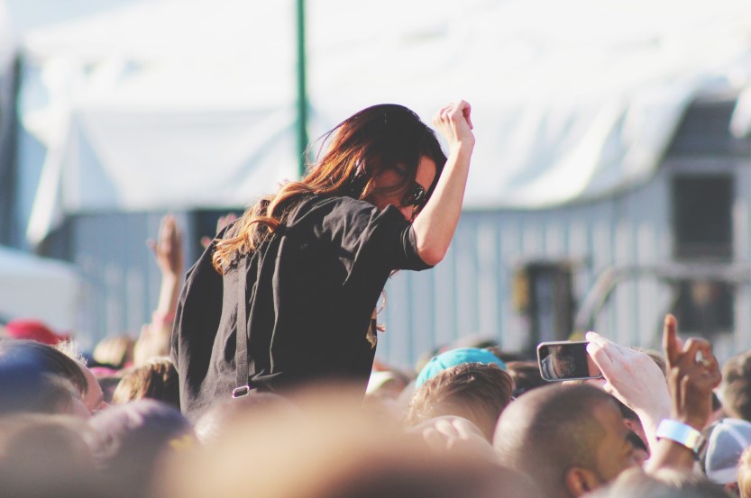 Woman on top of crowd at concert