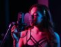 Voice type singing training: female singer recording vocals in studio with microphone